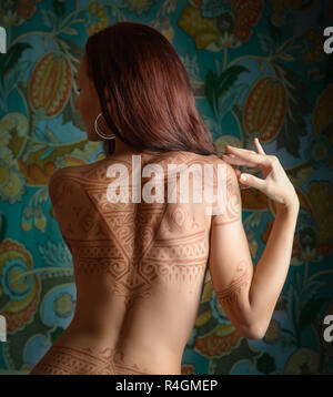 Beautiful woman with tattoo on her back. Stock Photo