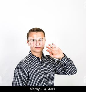 boy greets with his hands Stock Photo