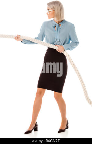 Concentrated beautiful businesswoman pulling rope isolated on white Stock Photo