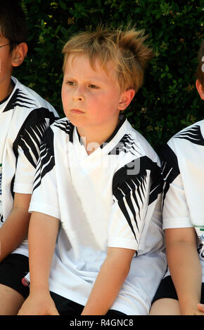 boy is looking angry and sad from soccer playing because they are not the winners Stock Photo