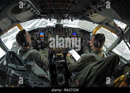 U.S. Air Force Capt. Frank Simon and U.S. Air Force Maj. Micah Yost, 351st Air Refueling Squadron pilots, perform preflight checks before conducting aerial refueling training during Exercise Trident Juncture 18, at Rovaniemi, Finland, Oct. 27, 2018. Trident Juncture is the largest NATO exercise since 2015, with participation of more than 50,000 military members from 31 nations. The 100th Air Refueling Wing supported the exercise with two KC-135s and crew. Stock Photo