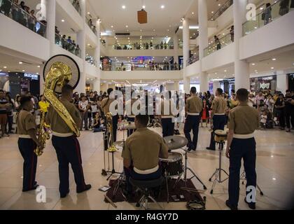 KOTA KINABALU, Malaysia (August 11, 2018) - Marines with the III Marine Expeditionary Force Band perform at Suria Sabah Mall in Kota Kinabalu, Malaysia in support of Cooperation Afloat Readiness and Training (CARAT) 2018. CARAT Malaysia in its 24th iteration, is designed to enhance information sharing and coordination, build mutual warfighting capability and support long-term regional cooperation enabling both partner armed forces to operate effectively together as a unified maritime force. Stock Photo