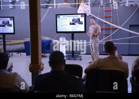 GREAT LAKES, Ill (September 27, 2018) Chief Fire Controlman Aegis John Keller, staff at Center for Surface Combat Systems Unit Great Lakes, gives a presentation to Naval Education and Training Command Commander Rear Adm. Kyle Cozad Sept. 27. Stock Photo