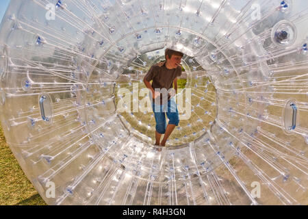 child has a lot of fun in the Zorbing Ball Stock Photo