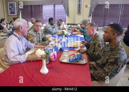 SOTO CANO AIR BASE, HONDURAS – Rep. Bradley Byrne, a Congressman for Alabama’s 1st Congressional District, shares lunch with U.S. Marines Capt. Brad Cook and Sgt. Julian Johnson during a Congressional Delegation visit to Soto Cano Air Base, September 30. The congressional delegation also received a brief from the SPMAGTF about the task force's capabilities and mission. The Marines and Sailors of SPMAGTF-SC are conducting security cooperation training and engineering projects alongside partner nation military forces in Central and South America. The unit is also on standby to provide humanitari Stock Photo