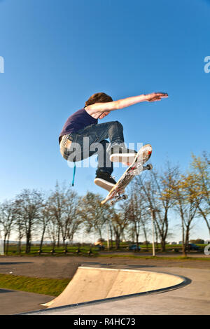 boy going airborne with the skate board Stock Photo