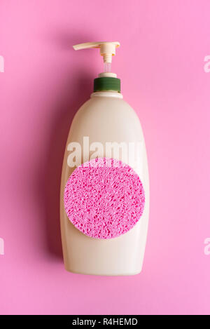 Large package shampoo, shower gel, body cream, Spa, sponge. Top view copy space pink background Stock Photo