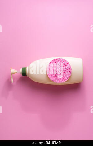 Large package shampoo, shower gel, body cream, Spa, sponge. Top view copy space pink background Stock Photo