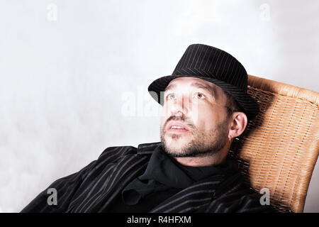 Bearded Man With Pierced Ear In Black Hat Stock Photo