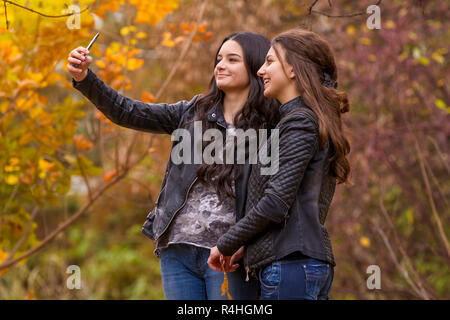 Girlfriends taking selfie picture with smartphone Stock Photo