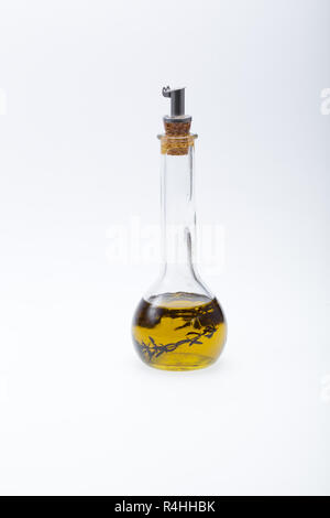 Thyme infused olive oil over white background Stock Photo