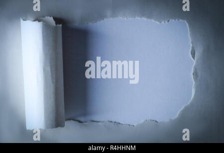 hole in the paper with torn edges.background. Stock Photo