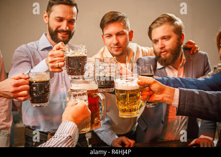 Group of friends enjoying evening drinks with beer Stock Photo