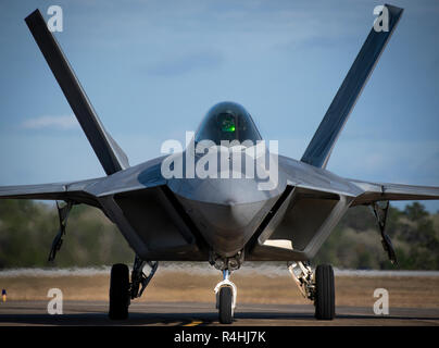 A 325th Fighter Wing F-22A Raptor taxis at Eglin Air Force Base, Fla., Nov. 20.  The first six Raptors arrived to their temporary home at Eglin from Tyndall Air Force Base.  This move is part of mission shift by the Air Force as Hurricane Michael recovery efforts continue at Tyndall.  (U.S. Air Force photo/Samuel King Jr.) Stock Photo