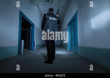Security Guard Standing In Corridor Of Building Stock Photo