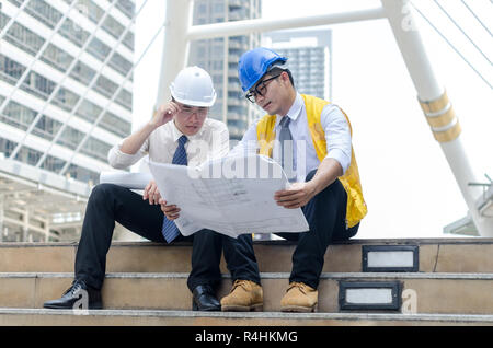 Two asian architects discussing about new project. Stock Photo
