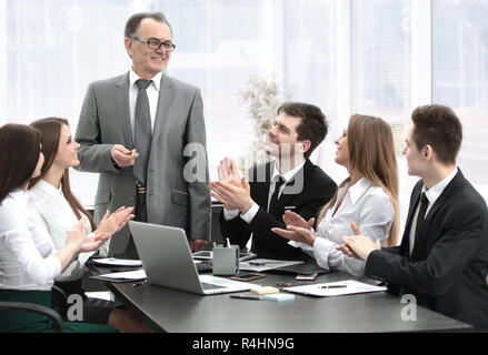 business team applauding leaders at the meeting. Stock Photo