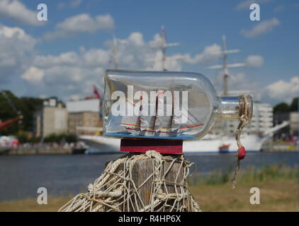 sailcloth ship in closed with cork bottle on harbor background Stock Photo