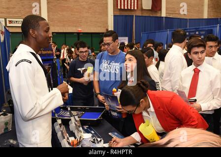 EDINBURG, Texas – (Oct. 1, 2018) Aviation Boatswain’s Mate (Equipment) Jene Maxwell of Los Angeles assigned to Navy Recruiting Station McAllen talks with Heather Stevenson, a junior attending Pharr-San Juan-Alamo Early College High School in San Juan, Texas, regarding a career in America’s Navy during the Hispanic Engineering Science and Technology (HESTEC) STEM + ME Expo being held on the campus of the University of Texas-Rio Grande Valley.  Through a collaboration with Workforce Solutions, the event included exhibitors from different industries, to include Navy Recruiting District San Antoni Stock Photo