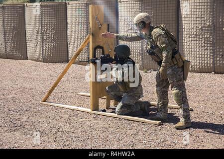 A U.S. Army Green Beret Soldier, assigned to 10th Special Forces Group (Airborne), mentors a critical enabler through a stress shoot at Fort Carson, Colorado, Sept. 28, 2018.  The training showcased their preparedness for future deployments and their readiness to fight at a moments notice. Stock Photo