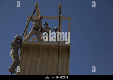 U.S. Marines with Alpha Company,1st Battalion, 3rd Marine Regiment, practice fast-roping techniques during Talon Exercise (TalonEx) 2018 at Yuma Proving Grounds, Arizona, Sept.21, 2018. TalonEx is a pre-deployment exercise in conjunction with the Weapons and Tactics Instructors Course that gives Marine ground combat elements the opportunity to work directly with air combat elements in real world scenarios. Stock Photo