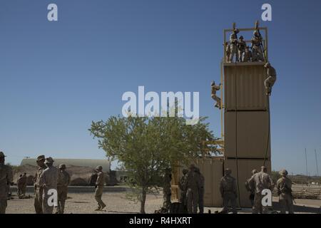 U.S. Marines with Alpha Company, 1st Battalion, 3rd Marine Regiment, practice fast-roping techniques during Talon Exercise (TalonEx) 2018 at Yuma Proving Grounds, Arizona, Sept.21, 2018. TalonEx is a pre-deployment exercise in conjunction with the Weapons and Tactics Instructors Course that gives Marine ground combat elements the opportunity to work directly with air combat elements in real world scenarios. Stock Photo