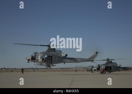 U.S. Marines with Alpha Company, 1st Battalion, 3rd Marine Regiment, prepare to conduct fast-rope training from a UH-1Y Venom helicopter during a simulated raid on an embassy during Talon Exercise (TalonEx) 2018 at Yuma Proving Grounds, Arizona, Sept. 27, 2018. TalonEx is a pre-deployment exercise in conjunction with the Weapons and Tactics Instructors Course that gives Marine ground combat elements the opportunity to work directly with air combat elements in real world scenarios. Stock Photo