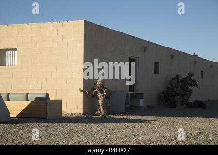 U.S. Marines with Alpha Company, 1st Battalion, 3rd Marine Regiment, conduct a simulated raid on an embassy during Talon Exercise (TalonEx) 2018 at Yuma Proving Grounds, Arizona, Sept. 27, 2018. TalonEx is a pre-deployment exercise in conjunction with the Weapons and Tactics Instructors Course that gives Marine ground combat elements the opportunity to work directly with air combat elements in real world scenarios. Stock Photo