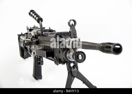 The M249 light machine gun, formerly designated the M249 Squad Automatic Weapon (SAW) and formally written as Light Machine Gun, 5.56 mm, M249, is the American adaptation of the Belgian FN Minimi, a light machine gun manufactured by the Belgian company FN Herstal (FN). The weapon was introduced in 1984 after being judged the most effective of a number of candidate weapons to address the lack of automatic firepower in small units. The M249 provides infantry squads with the high rate of fire of a machine gun combined with accuracy and portability approaching that of a rifle.    The M249 is gas o Stock Photo