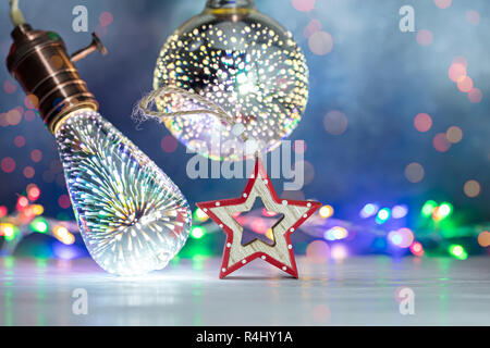retro light lamps and decorative christmas wooden handmade star against blue background with glowing multicolor lights Stock Photo