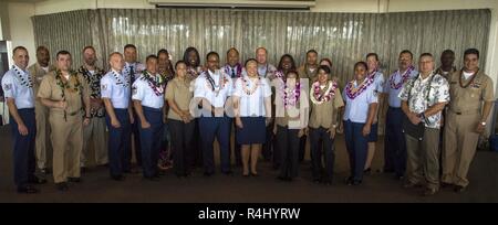 PEARL HARBOR (Oct. 26, 2018) Joint Base Pearl Harbor-Hickam (JBPHH) active-duty and reserve Airmen, Sailor and Department of Defense civilian college graduates pose for a photograph after being honored at the 2018 JBPHH College Graduation Recognition Ceremony held on the Hickam Officer's Club Lanai. 49 service members and civilians were recognized at the ceremony. Stock Photo