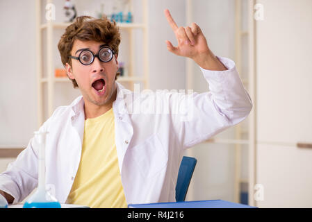 Funny crazy chemist doing experiments and tests Stock Photo