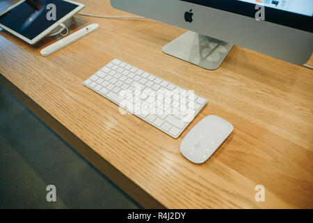 Berlin, August 29, 2018 Products of the company Apple. IMac, keyboard and computer mouse on the table. Not far lies the tablet of the same company. Products are presented in the official Apple Store Stock Photo