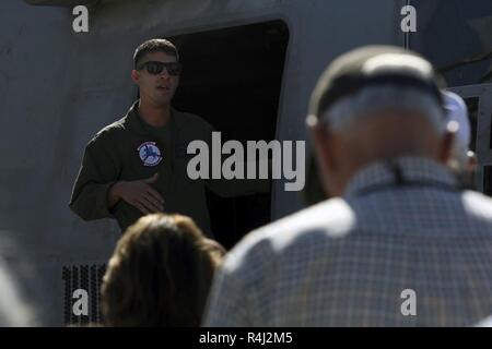 1st Lt. Cory Ferns, an MV-22B Osprey pilot with Marine Medium Tiltrotor Squadron (VMM) 162, explains the purpose of the MV-22B to members of the U.S. Naval Academy Alumni Association at Marine Corps Air Station Miramar, Calif., Oct. 26. Members of the U.S. Naval Academy Alumni Association visited MCAS Miramar to get an idea of what it’s like to be stationed at MCAS Miramar Stock Photo