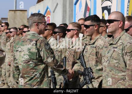 Laghman Province, Afghanistan (October 27, 2018) – Gen. James C. McConville, Vice Chief of Staff of the Army, recognizes Sgt. Victor Dios, a Miami, Fla. Native Infantryman from 2nd Battalion, 23rd Infantry Regiment, 1st Stryker Brigade Combat Team, 4th Infantry Division, for his outstanding performance as the force protection squad leader and his dedication to Operation Freedom's Sentinel and Resolute Support Mission. Stock Photo