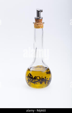 Thyme infused olive oil over white background Stock Photo