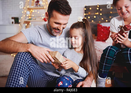 Girl giving christmas present to her father Stock Photo