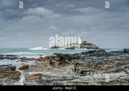 This is Godrevy Lighthouse which is situated in the Atlantic Sea on a small island just off Gwithian Sands, Hayle, Cornwall. Bad weather is coming in. Stock Photo