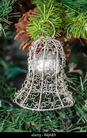 Christmas tree hanging ornament, silver bell, close up Stock Photo