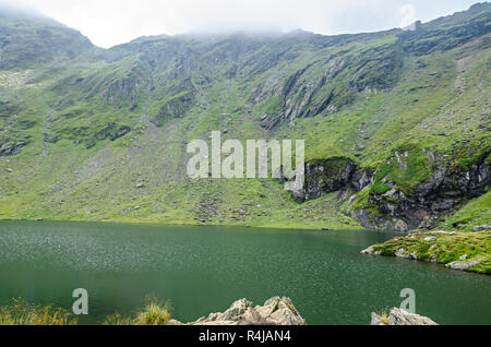 The glacier lake called Balea (Balea Lac) on the Transfagarasan road from Fagaras mountains. Stock Photo