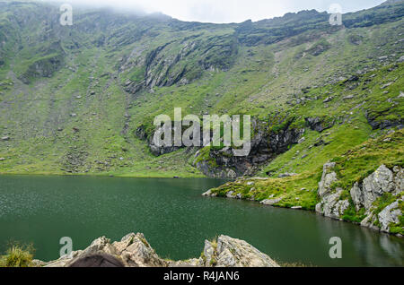 The glacier lake called Balea (Balea Lac) on the Transfagarasan road from Fagaras mountains. Stock Photo