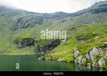 The glacier lake called Balea (Balea Lac) on the Transfagarasan road from Fagaras mountains. Stock Photo