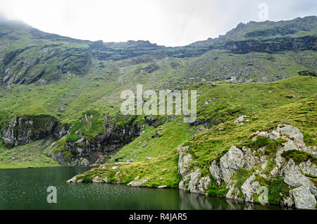 The glacier lake called Balea (Balea Lac) on the Transfagarasan road from Fagaras mountains. Stock Photo