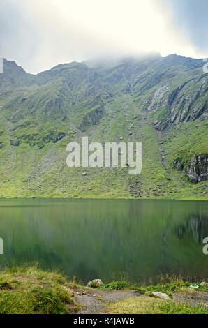 The glacier lake called Balea (Balea Lac) on the Transfagarasan road from Fagaras mountains. Stock Photo