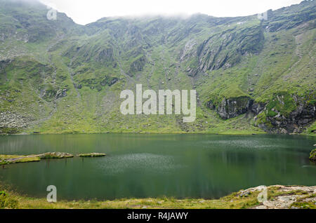 The glacier lake called Balea (Balea Lac) on the Transfagarasan road from Fagaras mountains. Stock Photo