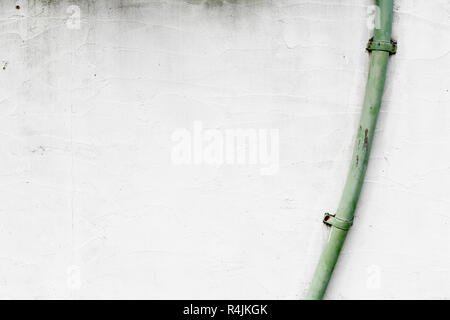 Part of a house with rain gutter on white wall Stock Photo