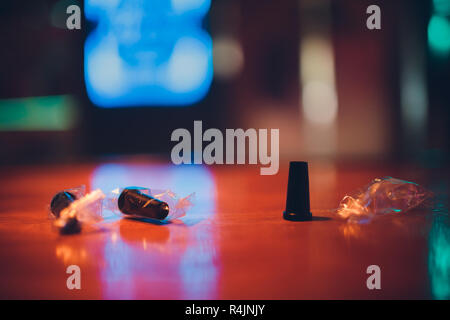 Plastic mouthpieces for hookah on the background of the bar, a hookah, wooden table. Stock Photo