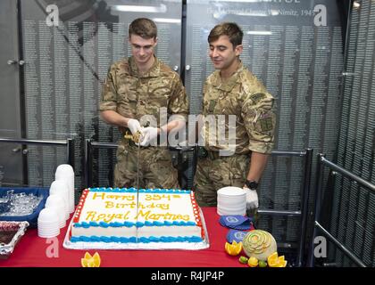 NORWEGIAN SEA (Oct. 28, 2018) British Royal Marine Commandos Marine William Christie, left, and Lance Cpl. Pieter Janse Van Rensburg, assigned to X-ray Company, 45 Commando Royal Marines, cut a cake to celebrate the Corps of Her Majesty’s Royal Marines’ 354th birthday in the Suribachi room aboard the Wasp-class Amphibious assault ship USS Iwo Jima Oct. 28, 2018 during exercise Trident Juncture 2018. Trident Juncture 2018 is a NATO-led exercise designed to certify NATO response forces and develop interoperability among participating NATO Allied and partner nations. Stock Photo