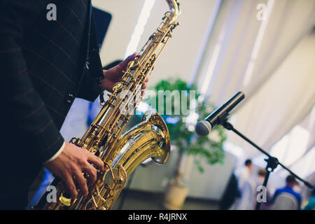 Musical instruments, Saxophone Player hands Saxophonist playing jazz music. Alto sax musical instrument closeup. Stock Photo