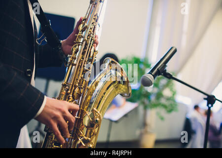 Musical instruments, Saxophone Player hands Saxophonist playing jazz music. Alto sax musical instrument closeup. Stock Photo